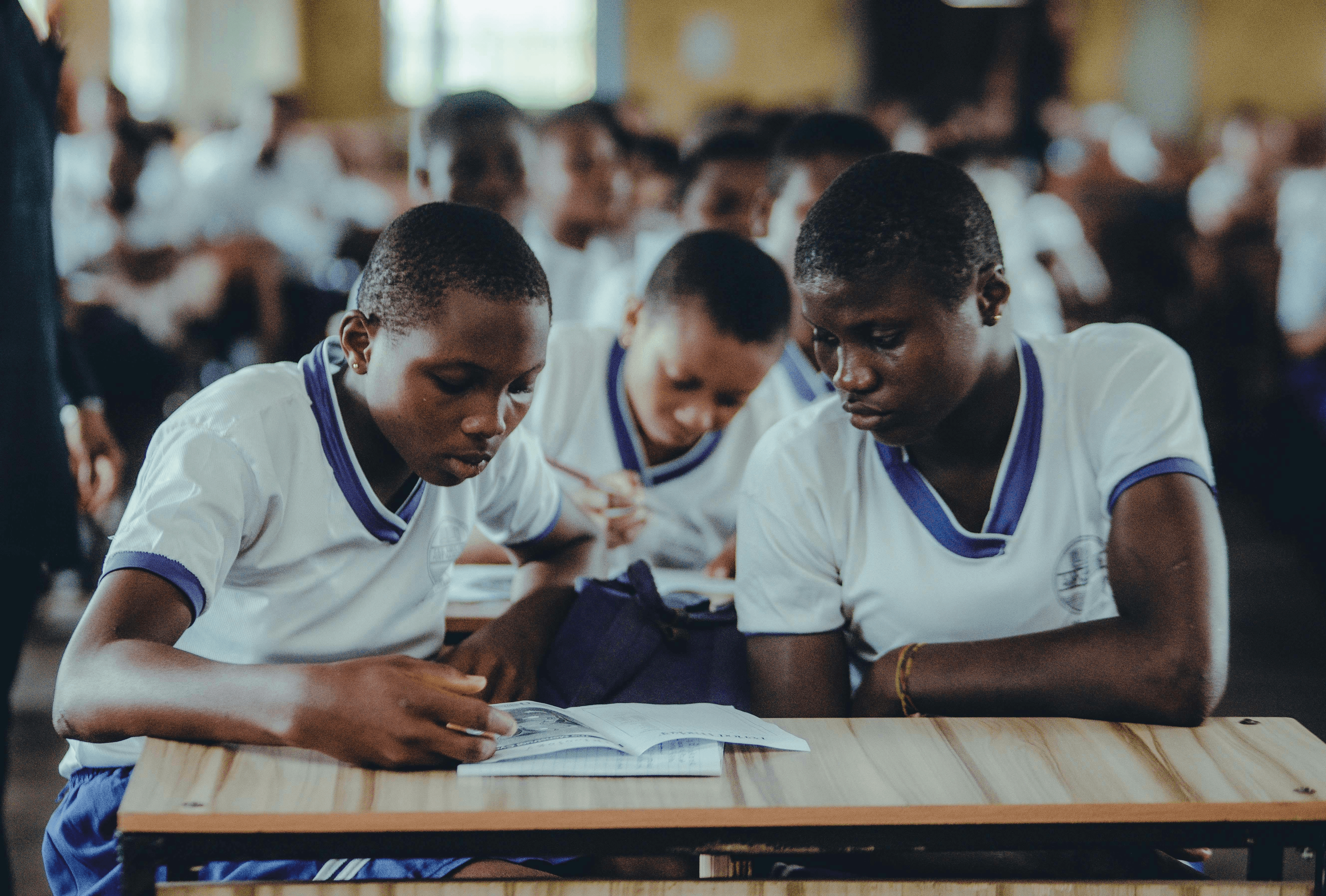 Matric learners studying from a textbook together